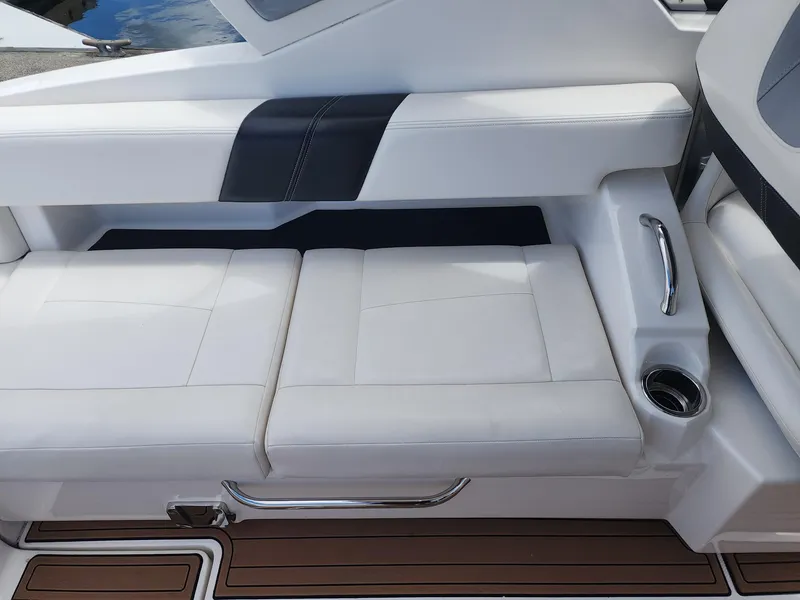 Slide: The Image of 2012 Chaparral 327 SSX boat interior with white leather seating and wood-style flooring. - 16