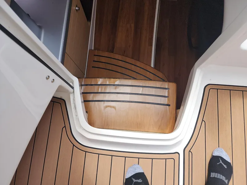 Slide: The Image of Interior stairs of 2012 Chaparral 327 SSX boat with wood finish and black accents. - 18