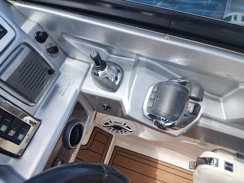 Slide: The Image of Control panel of 2012 Chaparral 327 SSX boat with throttle and speaker. - 19