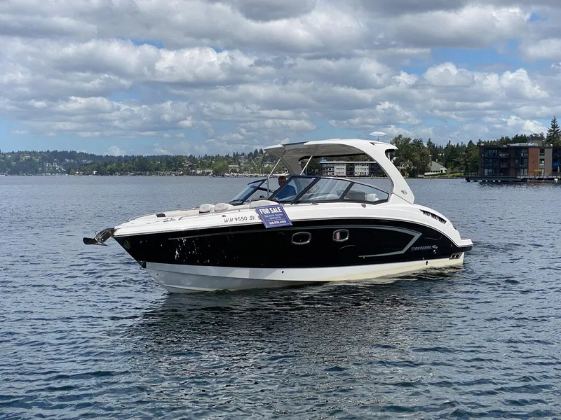 Slide: The Image of 2012 Chaparral 327 SSX boat on water, for sale sign visible. - 25