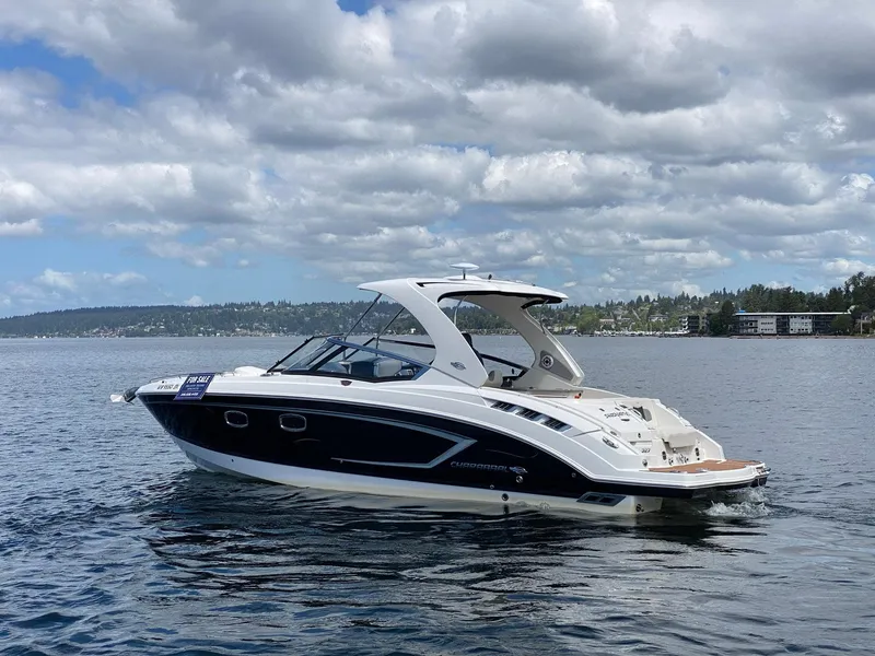 Slide: The Image of 2012 Chaparral 327 SSX boat on water, cloudy sky, "For Sale" sign visible. - 27