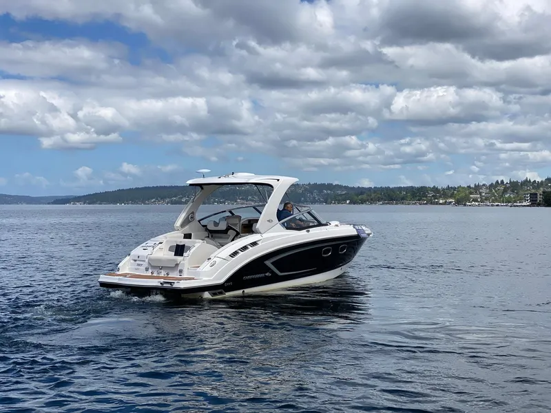 Slide: The Image of 2012 Chaparral 327 SSX boat cruising on a lake under a cloudy sky. - 30