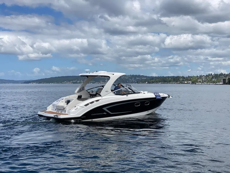 Slide: The Image of 2012 Chaparral 327 SSX boat cruising on a lake under a cloudy sky. - 31
