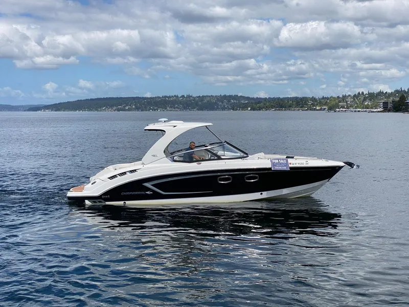 Slide: The Image of 2012 Chaparral 327 SSX boat on calm lake, for sale sign visible. - 32