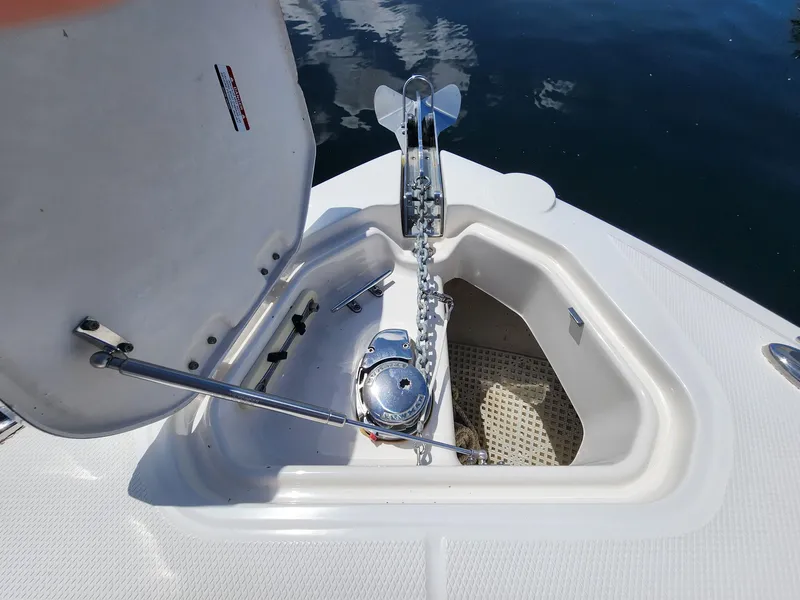 Slide: The Image of Anchor compartment of 2012 Chaparral 327 SSX boat with open hatch and chain. - 4