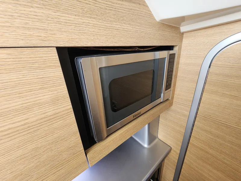 Slide: The Image of Built-in Haier microwave in 2012 Chaparral 327 SSX boat's wooden interior. - 8