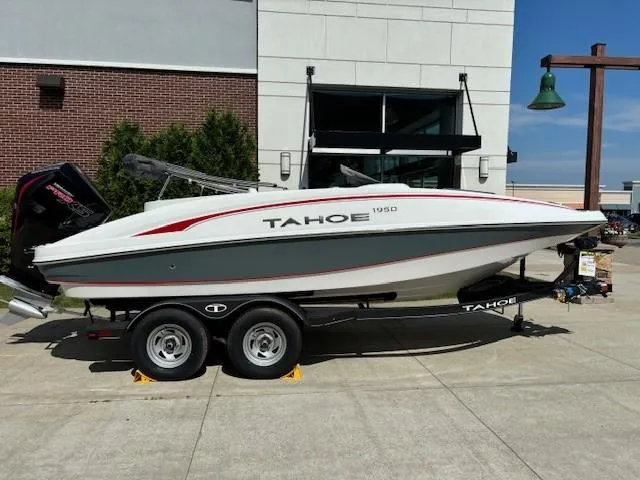 Slide: The Image of 2024 Tahoe 1950 boat on a trailer, parked outdoors. - 0