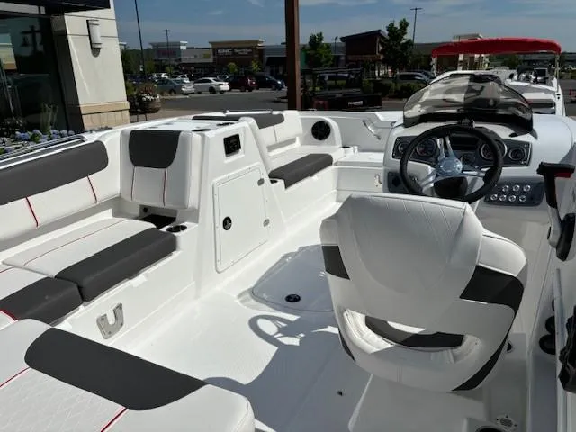 Slide: The Image of 2024 Tahoe 1950 boat interior with white and black seating, steering wheel, and dashboard. - 5