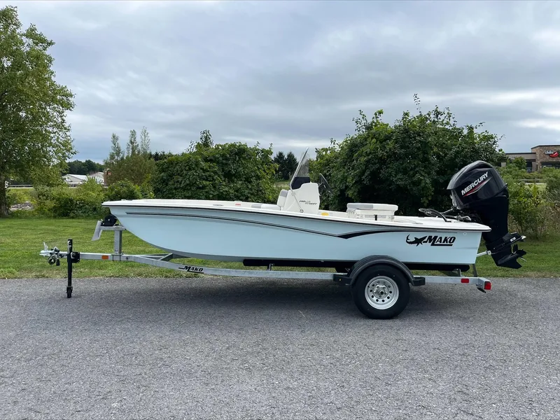 Slide: The Image of 2024 Mako Pro Skiff 15 CC boat on trailer, parked outdoors. - 0