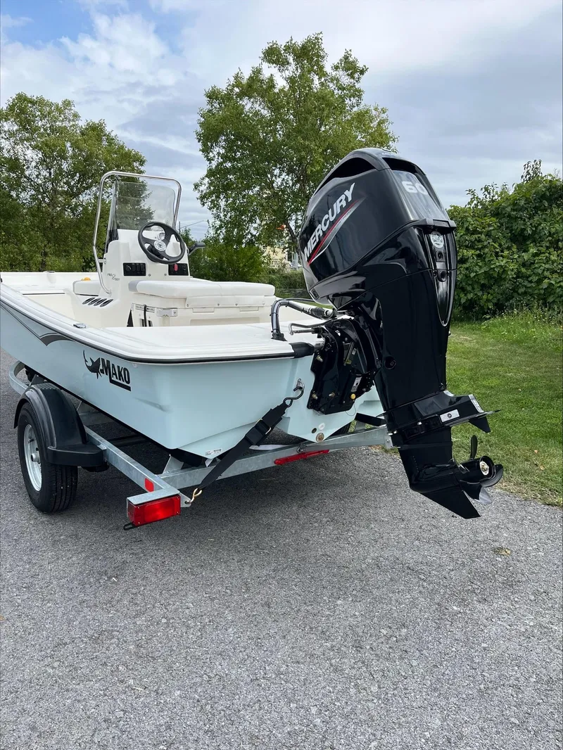 Slide: The Image of 2024 Mako Pro Skiff 15 CC boat with Mercury outboard motor on trailer. - 5