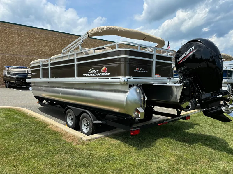 Slide: The Image of 2024 Sun Tracker SportFish 22 DLX pontoon boat on trailer with Mercury outboard motor. - 3