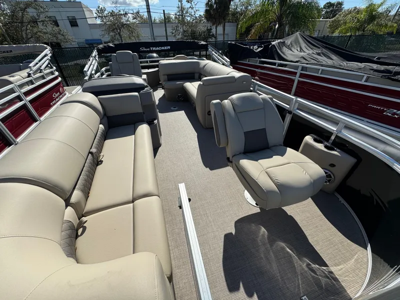 Slide: The Image of 2024 Sun Tracker SportFish 20 DLX pontoon boat interior with beige seating. - 1