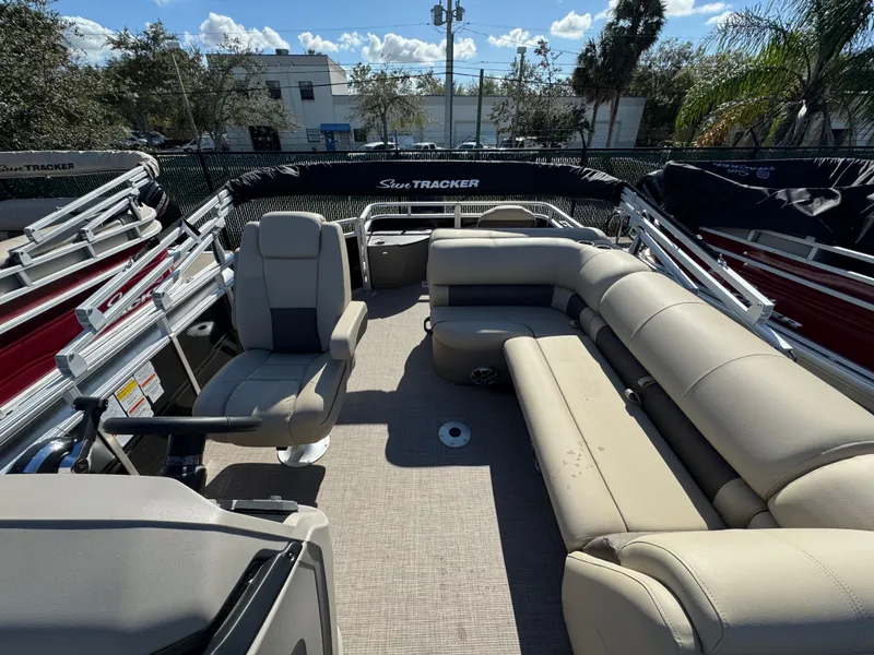 Slide: The Image of 2024 Sun Tracker SportFish 20 DLX pontoon boat with spacious seating and modern design. - 2