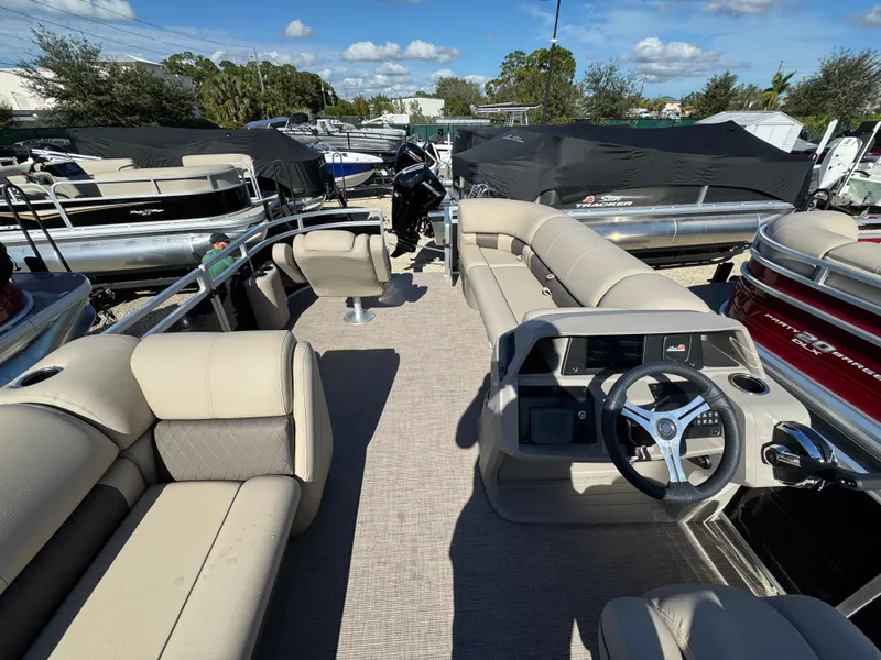 Slide: The Image of 2024 Sun Tracker SportFish 20 DLX pontoon boat with spacious seating and modern steering console. - 3