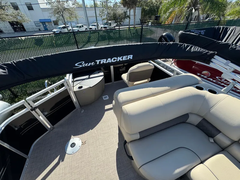 Slide: The Image of 2024 Sun Tracker SportFish 20 DLX pontoon boat interior with seating and canopy. - 4