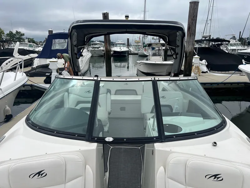 Slide: The Image of 2014 Monterey 288 SS boat docked at a marina, featuring a sleek design and spacious seating. - 11