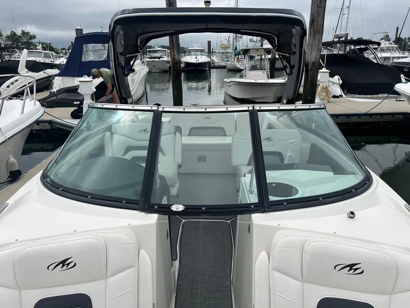 Slide: The Image of 2014 Monterey 288 SS boat docked at a marina, featuring a sleek design and spacious seating. - 12