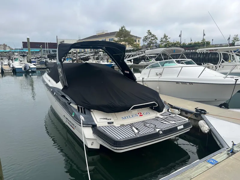 Slide: The Image of 2014 Monterey 288 SS boat docked at marina with black cover. - 14