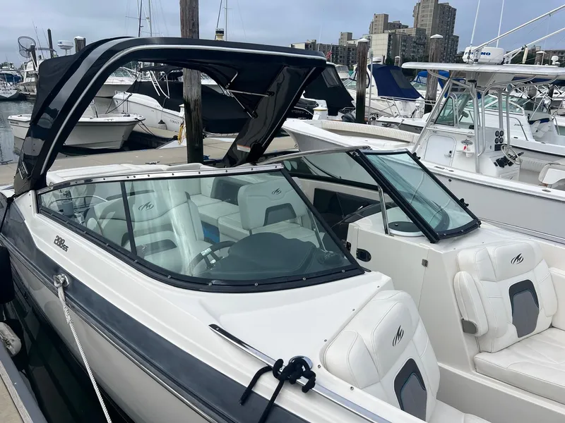 Slide: The Image of 2014 Monterey 288 SS boat docked at marina with other boats in background. - 18