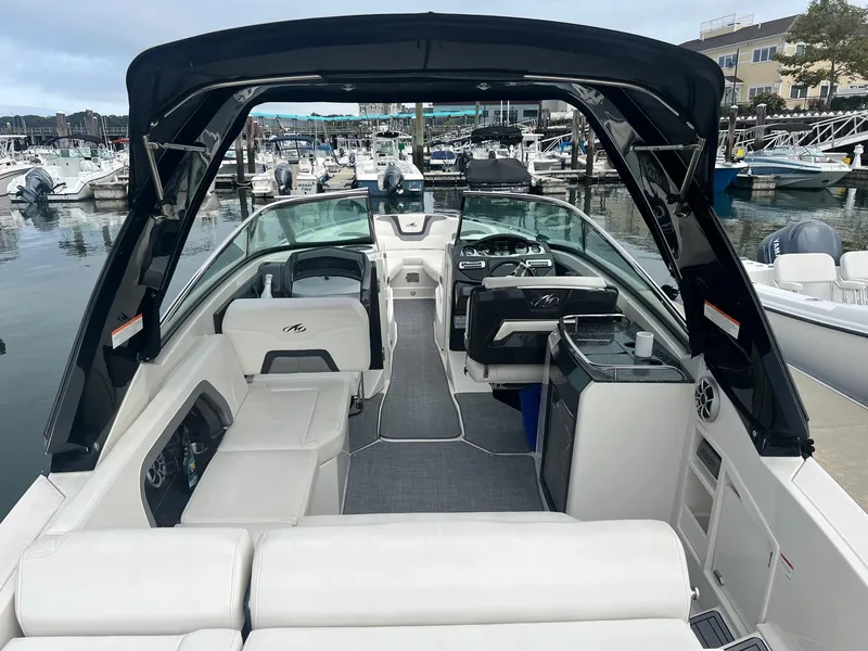 Slide: The Image of 2014 Monterey 288 SS boat interior with seating and helm at marina. - 19