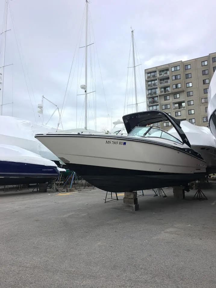 Slide: The Image of 2014 Monterey 288 SS boat on dry dock with cityscape background. - 2