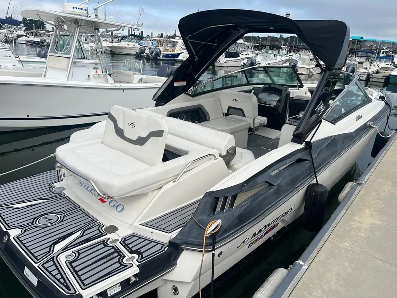 Slide: The Image of 2014 Monterey 288 SS boat docked at a marina, featuring a sleek design and spacious seating. - 20