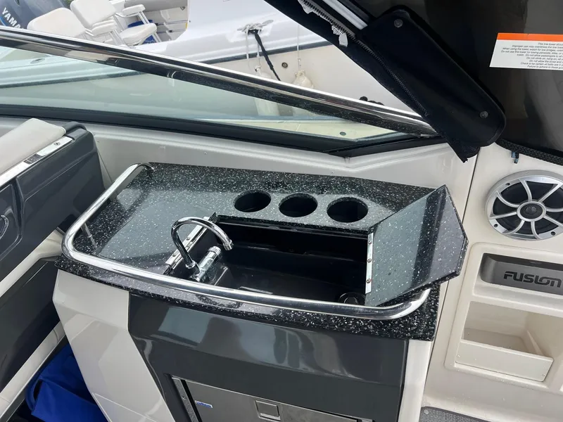 Slide: The Image of 2014 Monterey 288 SS boat interior with sink and storage compartments. - 25