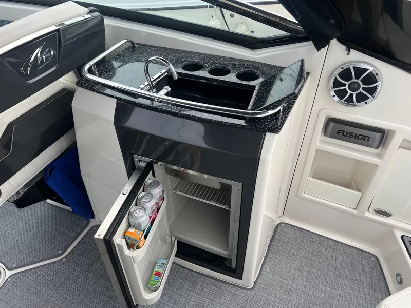 Slide: The Image of Monterey 288 SS 2014 boat interior with mini fridge and sink. - 26