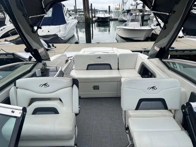 Slide: The Image of 2014 Monterey 288 SS boat interior with white seating at marina. - 27