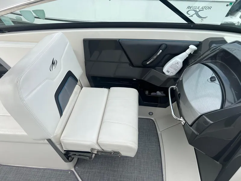 Slide: The Image of Interior of a 2014 Monterey 288 SS boat with white seating and dashboard. - 29