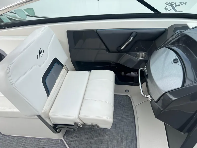 Slide: The Image of 2014 Monterey 288 SS boat interior with white seating and control panel. - 30
