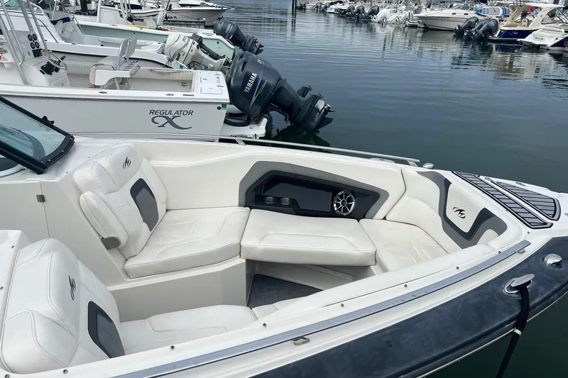 Slide: The Image of 2014 Monterey 288 SS boat with white leather seating docked at a marina. - 32