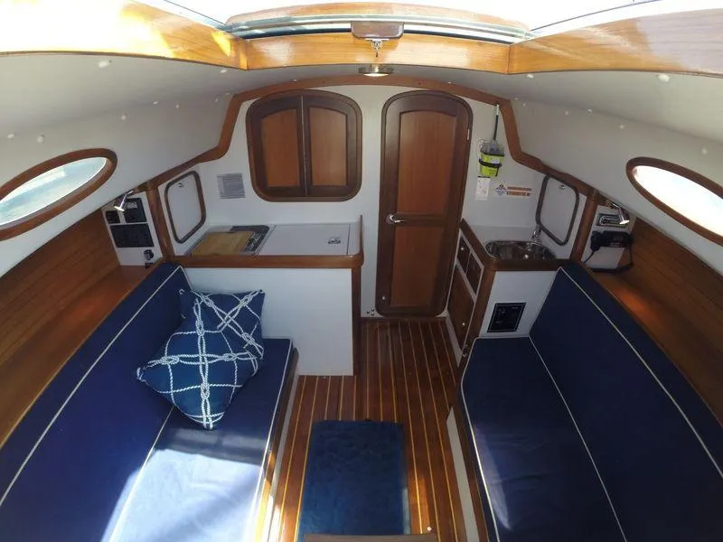 Slide: The Image of Interior of 2009 Alerion Express 33 sailboat with wooden finishes and blue seating. - 10