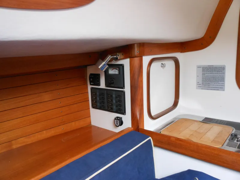 Slide: The Image of Interior of 2009 Alerion Express 33 sailboat with control panel and wooden accents. - 13