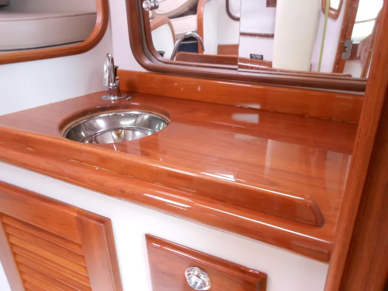 Slide: The Image of 2009 Alerion Express 33 yacht interior with polished wood countertop and stainless steel sink. - 15