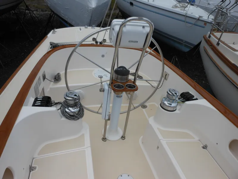 Slide: The Image of 2009 Alerion Express 33 sailboat cockpit with steering wheel and winches. - 2