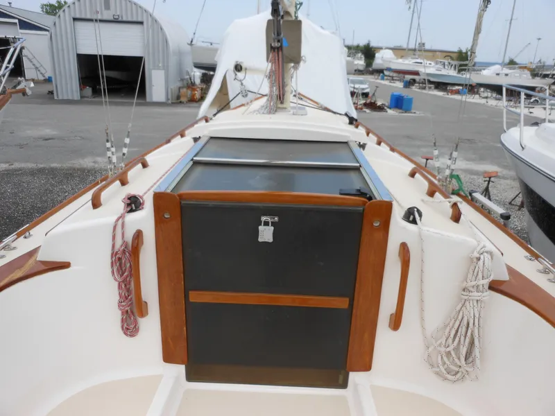 Slide: The Image of 2009 Alerion Express 33 sailboat cockpit with wooden trim and storage compartments. - 7