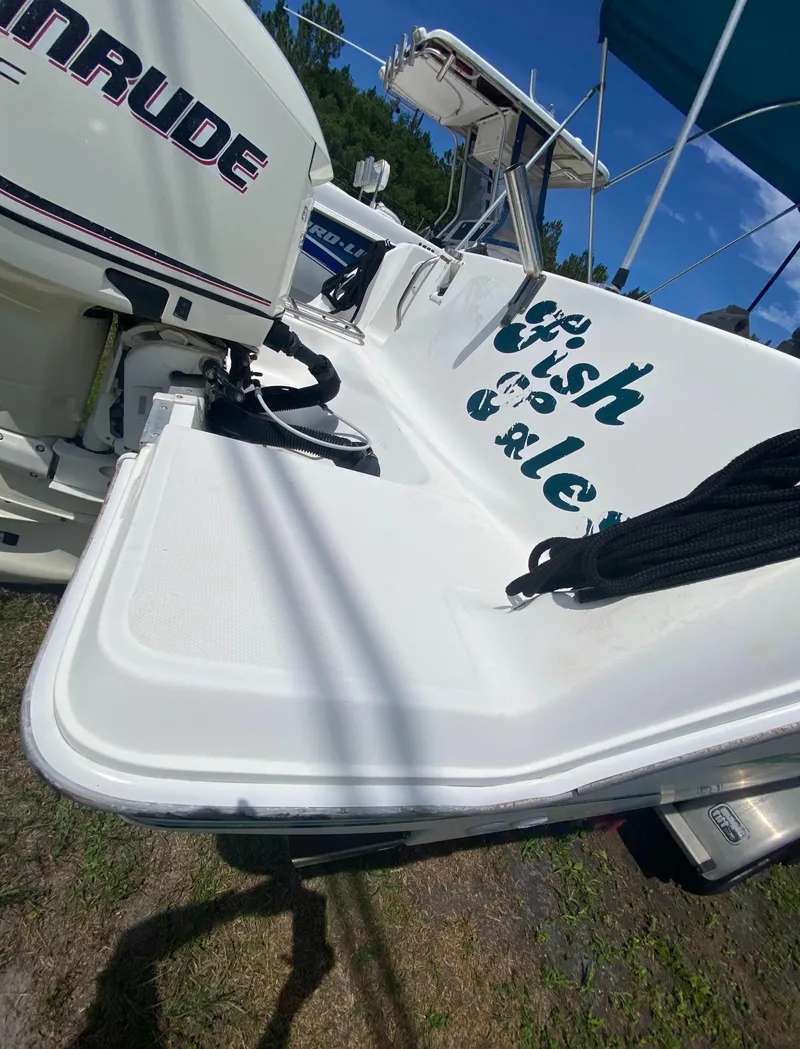 Slide: The Image of 1999 Aquasport 245 Explorer boat with Evinrude outboard motor. - 11