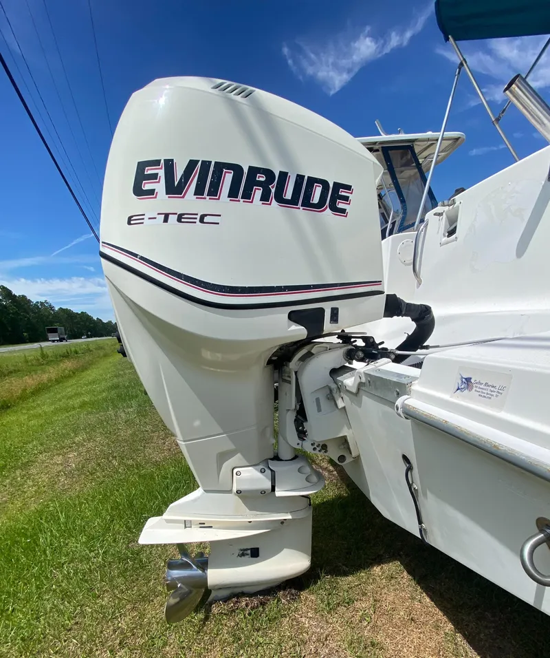 Slide: The Image of 1999 Aquasport 245 Explorer with Evinrude E-TEC outboard motor. - 12