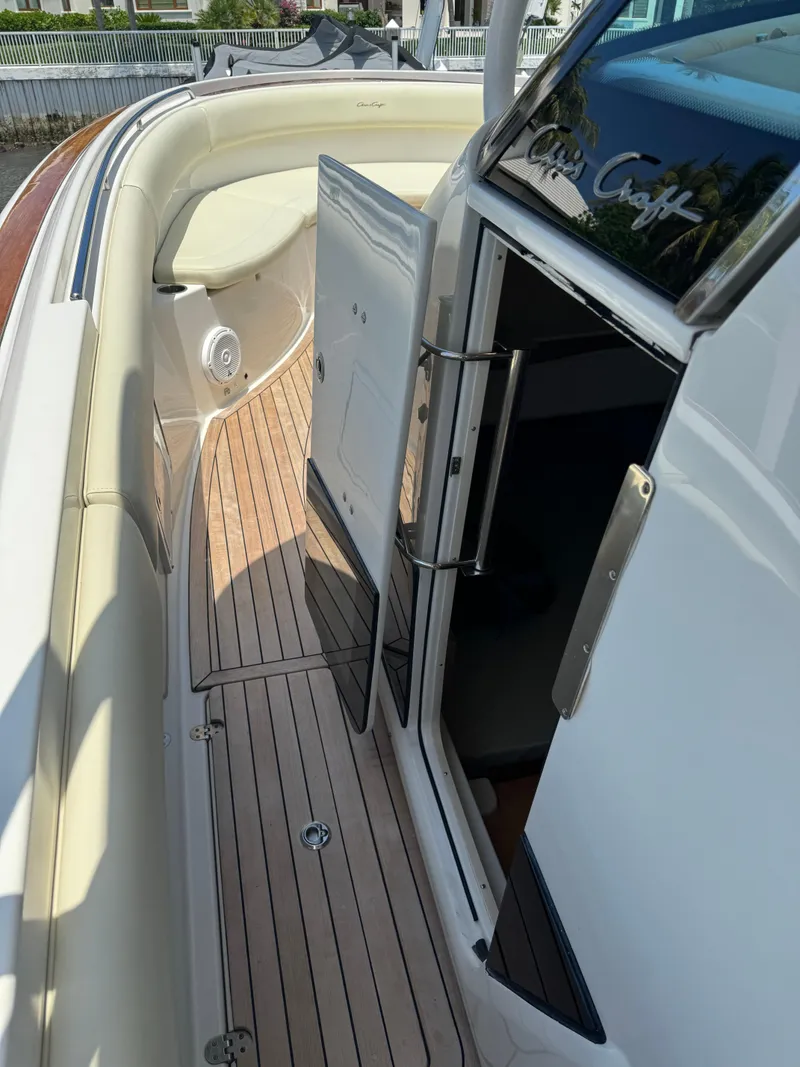 Slide: The Image of 2016 Chris-Craft Catalina 34 boat with open cabin door and teak deck. - 12