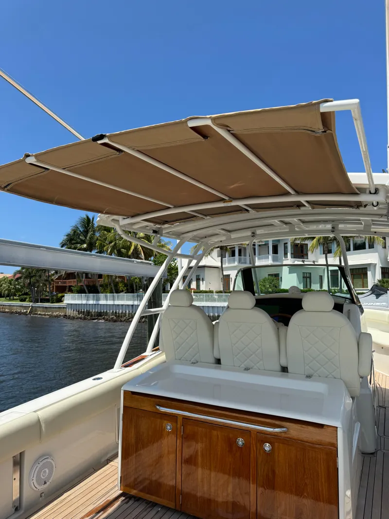 Slide: The Image of 2016 Chris-Craft Catalina 34 boat with shaded seating area and waterfront view. - 14