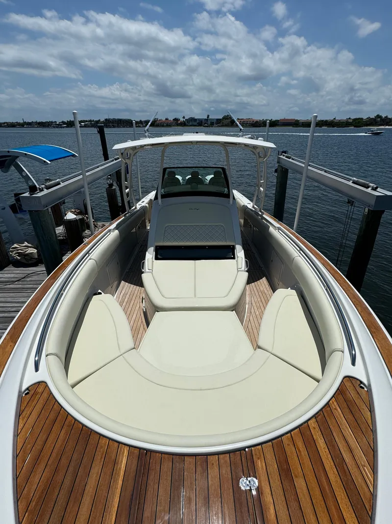 Slide: The Image of 2016 Chris-Craft Catalina 34 boat docked, showcasing spacious deck and seating. - 9