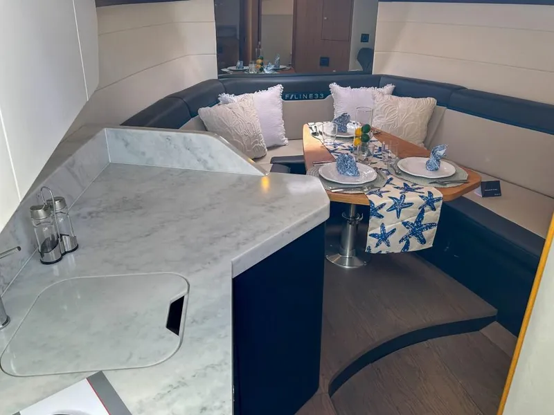 Slide: The Image of Interior of 2023 Fairline F//Line 33 Outboard with dining area and marble countertop. - 11