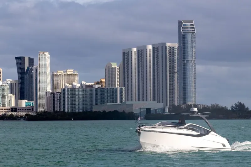 Slide: The Image of 2023 Fairline F//Line 33 Outboard cruising near city skyline. - 5