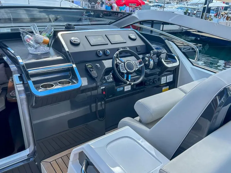 Slide: The Image of 2023 Fairline F//Line 33 Outboard boat cockpit with modern controls and steering wheel. - 10