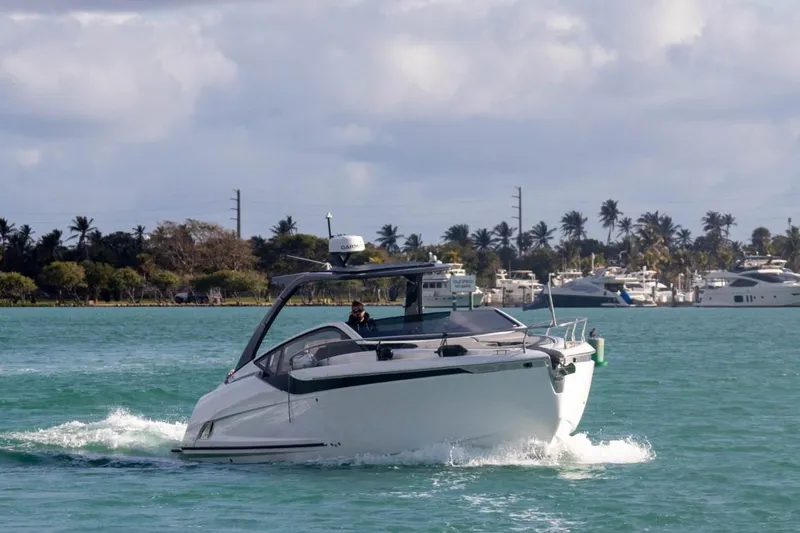 Slide: The Image of 2023 Fairline F//Line 33 Outboard cruising on a scenic waterway. - 2