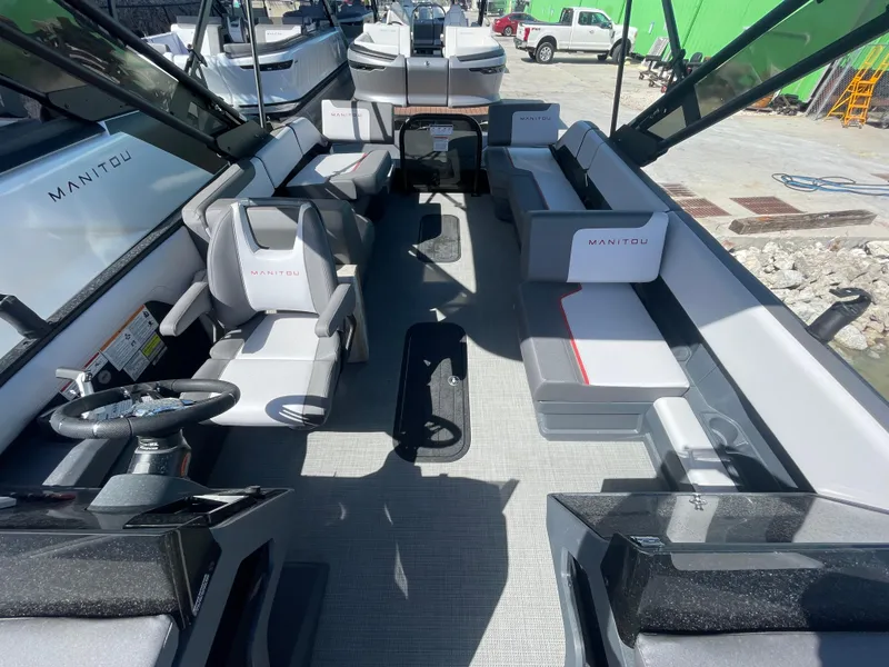 Slide: The Image of 2024 Manitou Cruise boat interior with modern seating and steering console. - 3