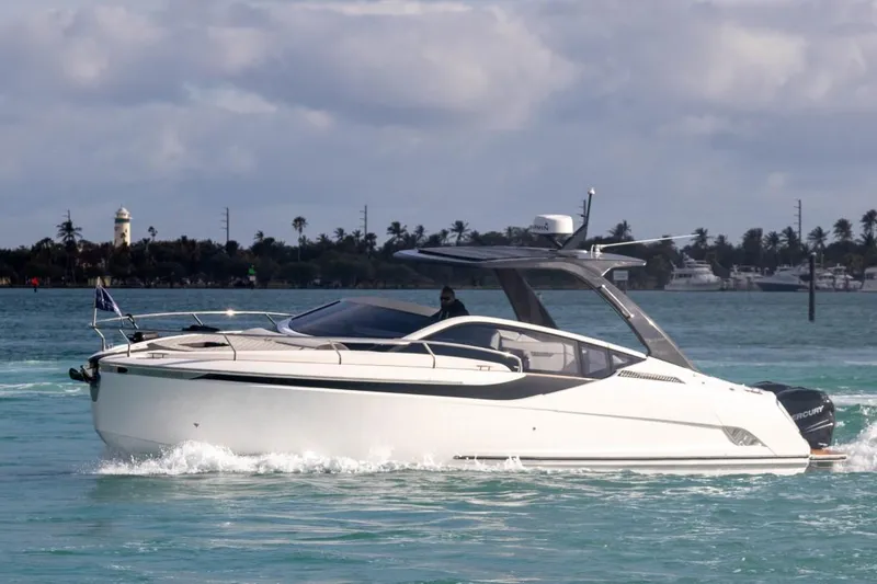 Slide: The Image of 2023 Fairline F//Line 33 Outboard luxury yacht cruising on water. - 1