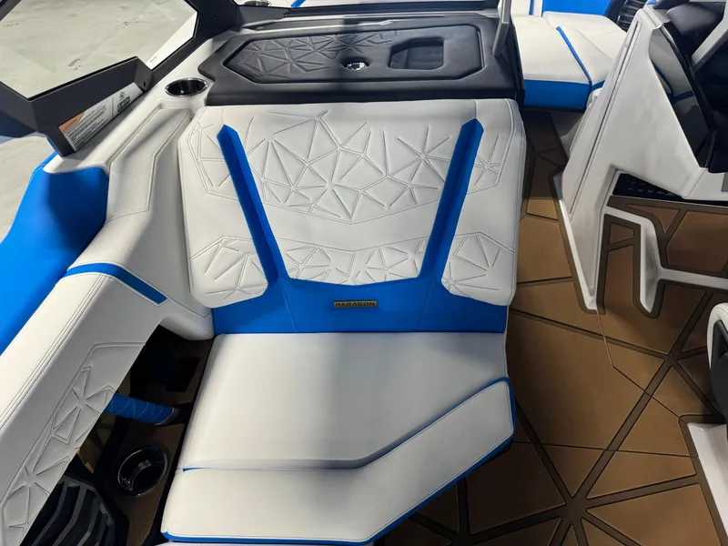 Slide: The Image of 2025 Nautique Super Air Nautique G25 Paragon interior with blue and white seating. - 11