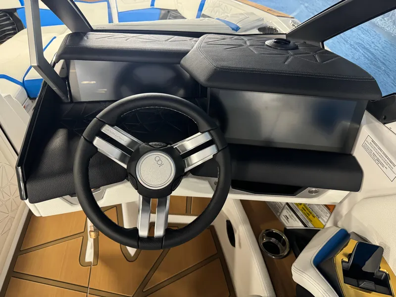 Slide: The Image of 2025 Nautique Super Air Nautique G25 Paragon dashboard with sleek steering wheel design. - 12